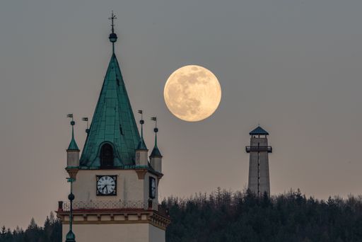A beautiful shot of a full supermoon behind the Tisnov church
