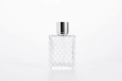 An elegant glass perfume bottle isolated on a white background