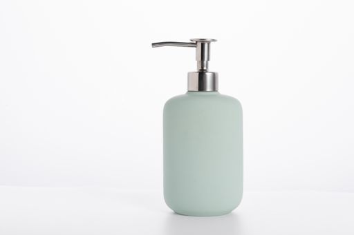A blue glass soap bottle isolated on a white background