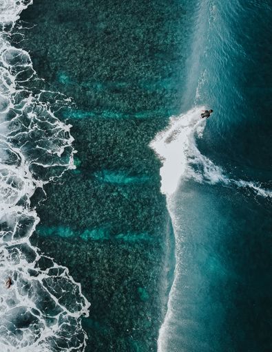 Surfing on blue waves in Maldives