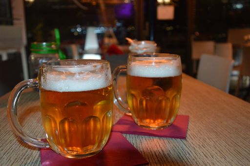 A selective focus shot of two glasses of beer on a table