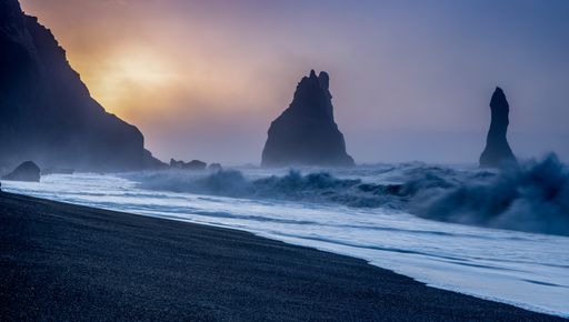 A breathtaking scenery of burning sunset over the waves of the ocean