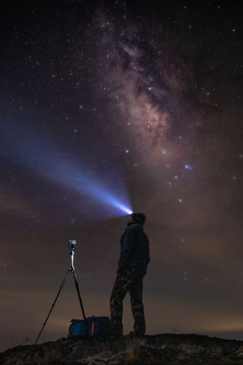 A vista scene of a photographer with a tripod on a hill desert of Sierra de Quila, Jalisco, Mexico