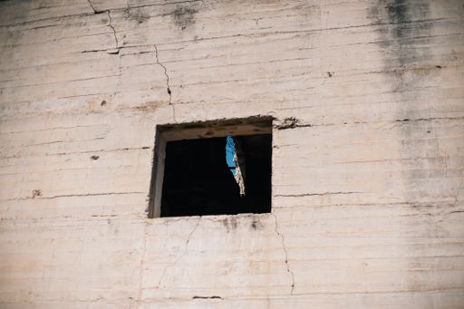 A closeup shot of an old cracked wall with a small opening