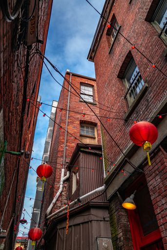 A low angle shot of Chinese lanterns in Fan Tan Alley, Chinatown, Victoria, BC Canada
