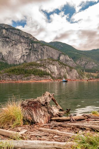 A low angle vertical shot of a river surrounded by a mountainous scenery in Squamish, BC Canada