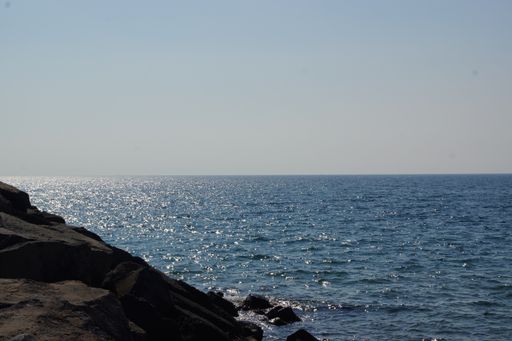 An amazing seascape view with shiny water surface and rocky coastline