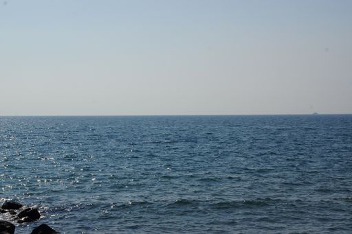 A beautiful view of the wavy ocean gleaming under the blue sky - great for wallpapers
