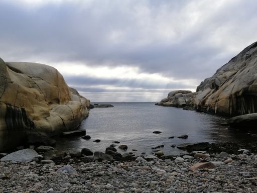 A beautiful shot of clear water surrounded by the rocky seashore in Ula, Norway