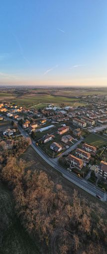 A vertical shot of a winter sunset over a landscape in the evening