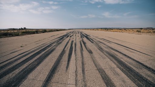 A panoramic view of a dusty road near the Negev desert, Israel with traces of tires