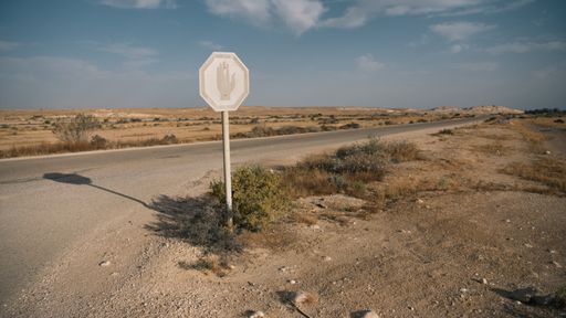 A panoramic view of a paved road going through the Negev desert, Israel