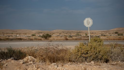 A panoramic view of a paved road going through the Negev desert, Israel