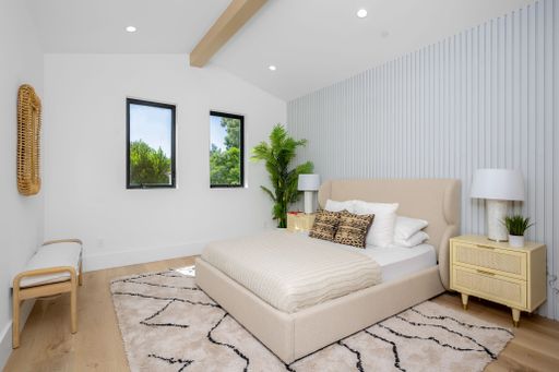 An Interior design of a modern house bedroom with white walls and furniture