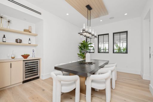 An Interior design of a modern house hall with white walls andbig table