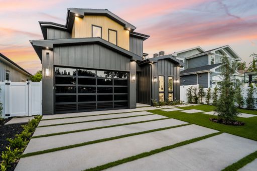 A modern concrete and steel home with a spacious outdoor living space