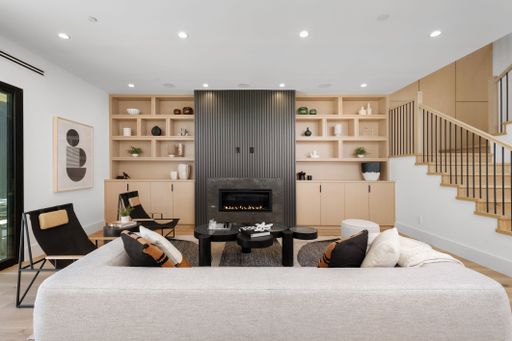 A cozy and inviting living room featuring a fireplace and two comfortable sofas adorned with decorative pillows