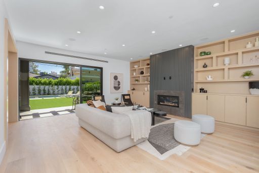 An inviting living room featuring a contemporary white sectional sofa positioned in front of a neutral-toned wall