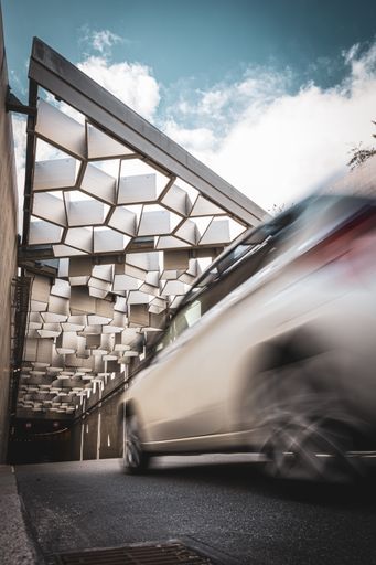 A vertical shot of a car on background of an abstract tunnel structure - perfect for wallpaper