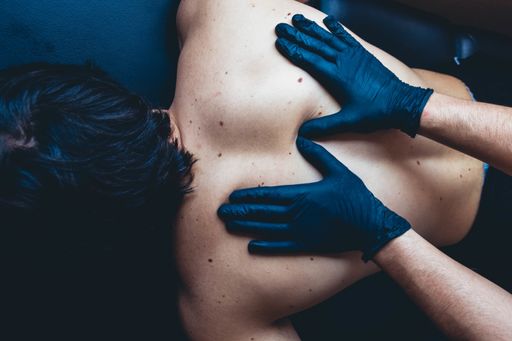 A high angle shot of a male doing a massage for a female with gloves