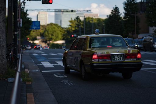 A Japanese Taxi driving on the street in Tokyo, Japan