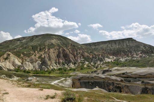 The Fairy rock formations against blue cloudy sky at Goreme National Park, Cappadocia, Turkey