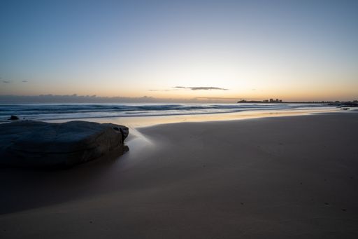 A fascinating shot of a sandy beach on background of the sunset
