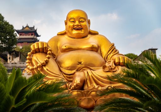 A big gold sculpture of a Laughing Buddha at Temple in China