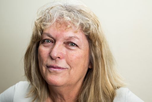 A Caucasian middle-aged woman with green eyes