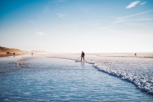 A beautiful view of a surfer coming up to the shore