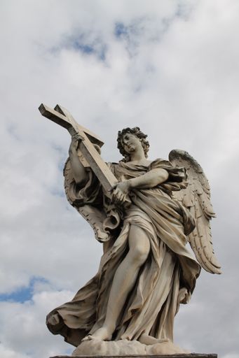 A vertical shot of the Bernini's marble statue of angel with cross from the St Angelo Bridge in Rome, Italy