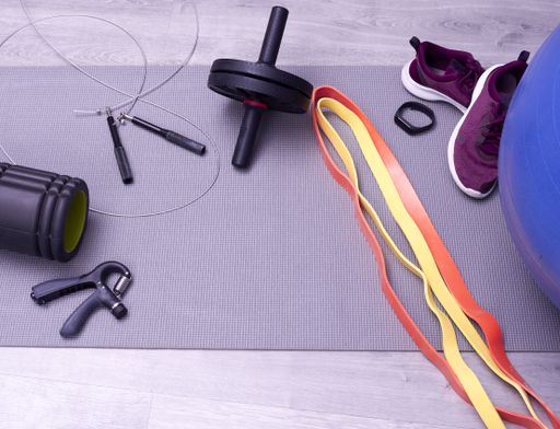 Different training tools dumbells and sports boots on the floor