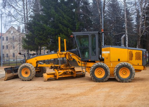An old tractor working in a construction site at daytime