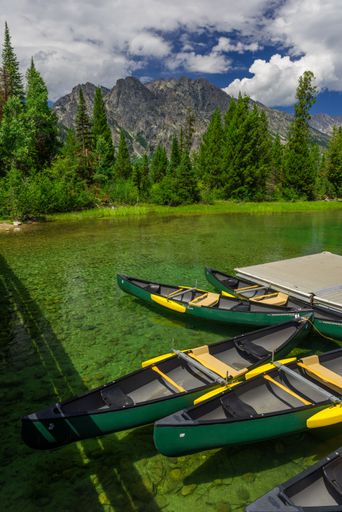 The Grand Teton National Park landscape with canoes floating on the water in Wyoming, United States