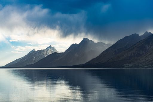 The Grand Teton National Park hills reflected in the water below in Wyoming, United States