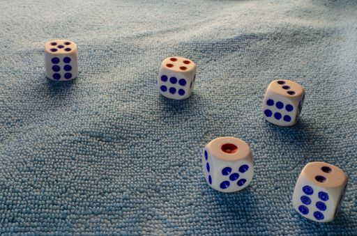 A closeup shot of five dice arranged from one to five