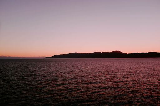 A beautiful scenery of a landscape near the body of water during sunset