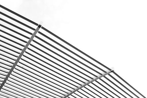 A low angle shot of the metal bars under the bright sky