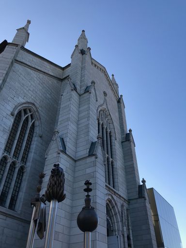 A vertical low angle shot of a beautiful church under the blue sky captured in Quebec, Canada