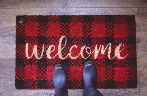 An overhead shot of a person standing on a welcome mat