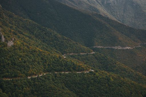 An aerial view of a dangerous mountain road passing through the forest in Vlasic, Bosnia