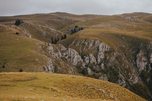 A high angle shot of rocky mountains in Vlasic,  Bosnia  on a gloomy day