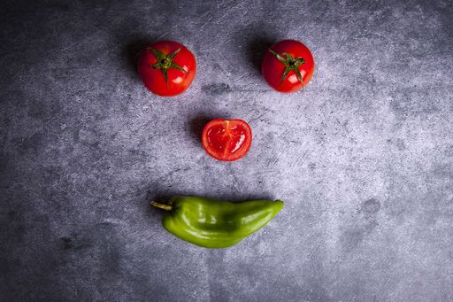 A top view shot of a smiley face made with vegetables - concept of healthy lifestyle
