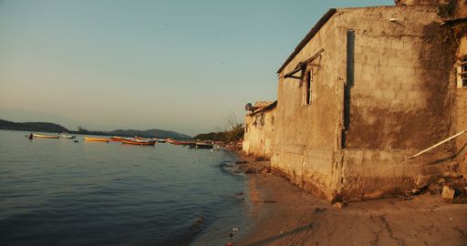 A beautiful shot of a weathered stone-made building on the beach in Rio de Janeiro during the sunset