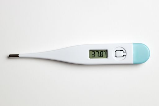 A digital thermometer on a white background marking high temperature