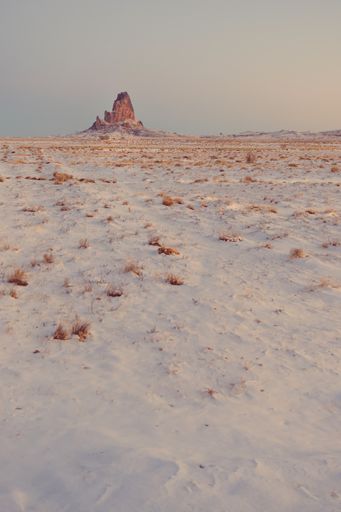 A vertical shot of sandstone formations of Navajo Nation's Monument Valley Park in Arizona, US