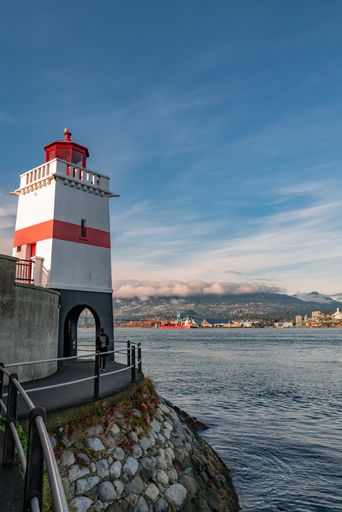 A vertical low angle shot of the Lighthouse on Seawall in Stanley Park, Vancouver