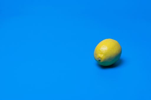 A juicy lemon on blue background with an empty space for a text