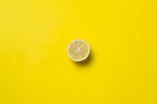A top view of a split lemon on yellow background with an empty space for a text