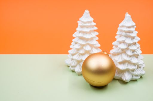 A high angle shot of Christmas ornaments on a colorful surface